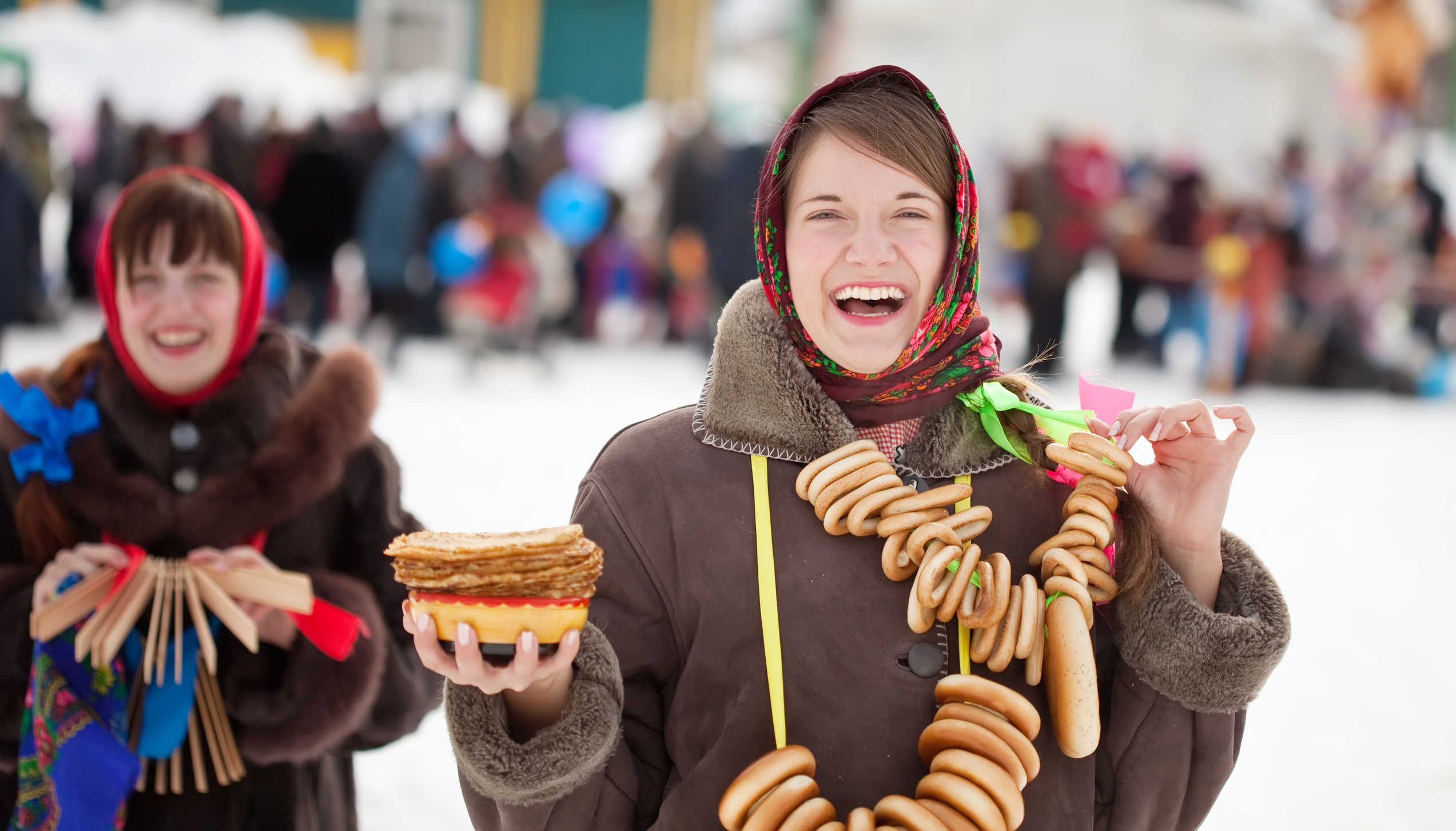 Two happy girls celebrating  Pancake Week at Russia